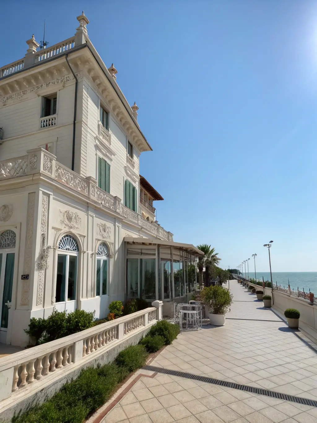 A wide shot of the Palazzina Azzurra in San Benedetto del Tronto, showcasing its architectural beauty and seaside location, to be used on the Nutrimente Festival website.
